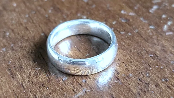 A finished domed band resting on the wooden bench top. (finished product)