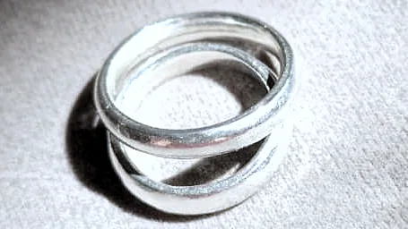 Two bands resting together on grey velvet, seen from slightly above. (finished product)
