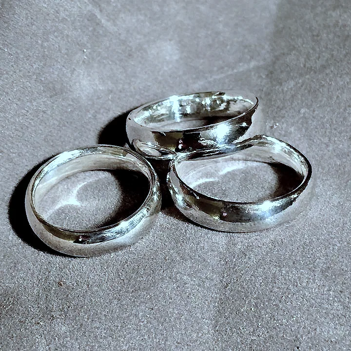 Three hand-made domed bands, one showing its join line. (finished product)