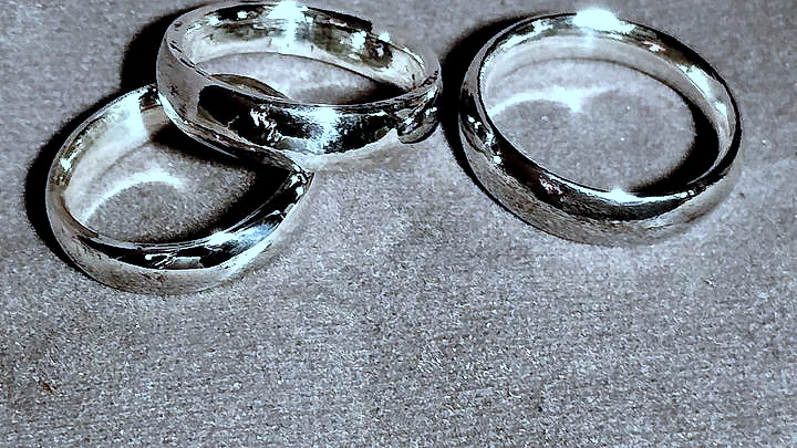 Three heavy domed silver bands grouped on suede. (finished product)