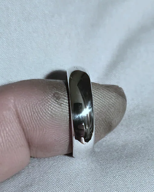 A domed band on the hand, reflecting the light. (finished product)
